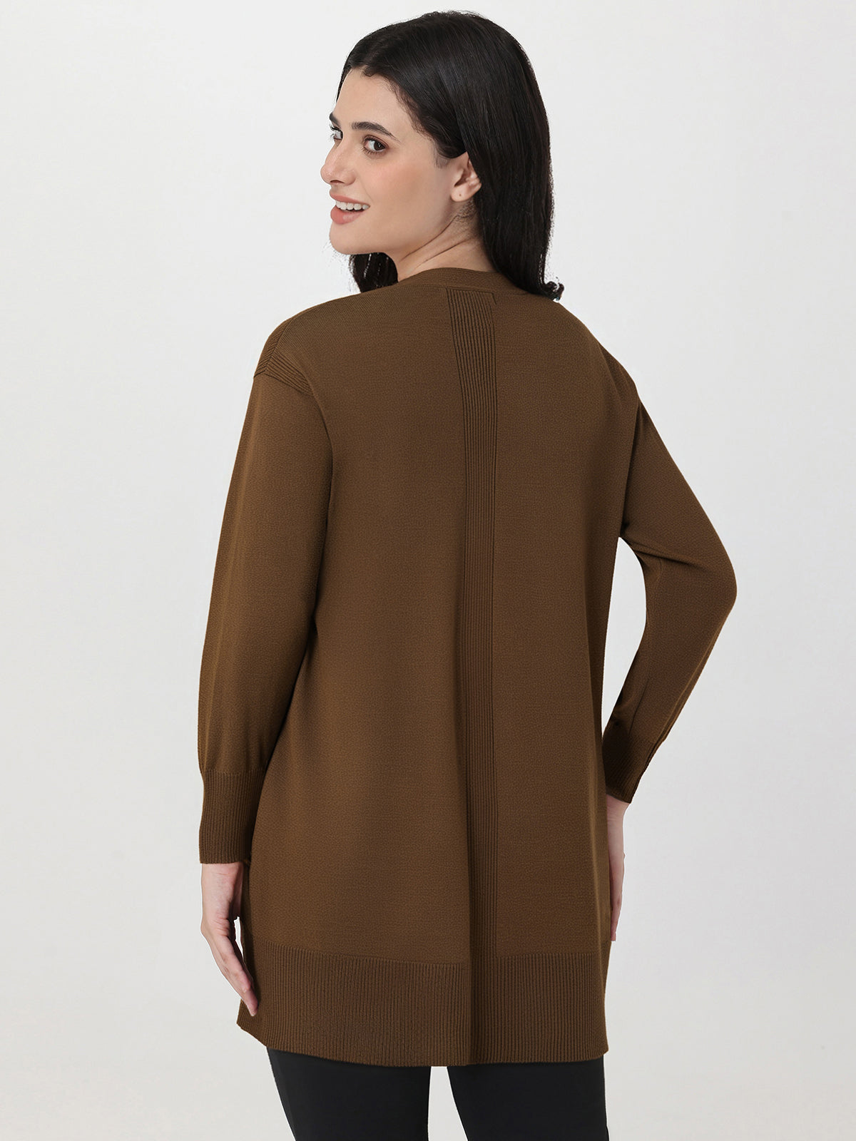 Woman wearing a brown sweater on a white background