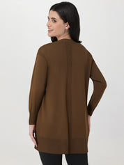 Woman wearing a brown sweater on a white background