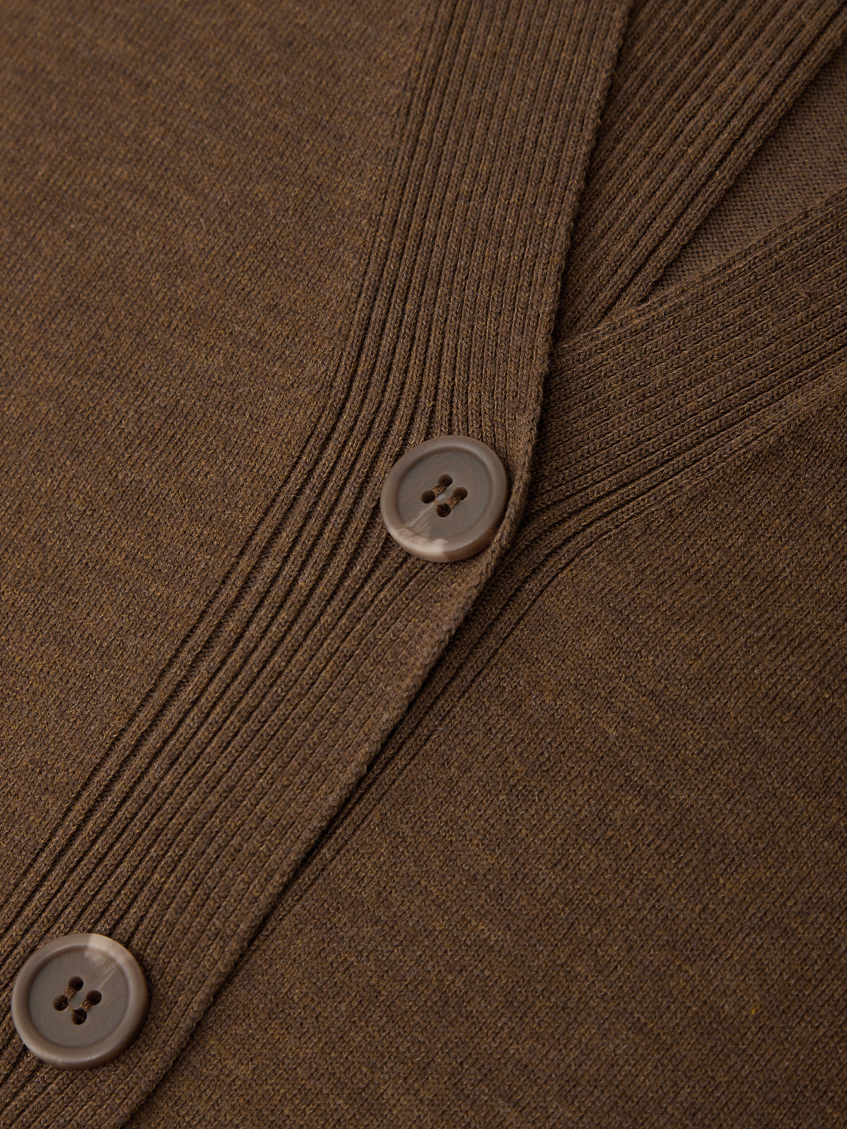 Close-up of a brown textured fabric with buttons