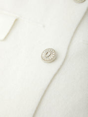 Close-up of a silver button on a white fabric background