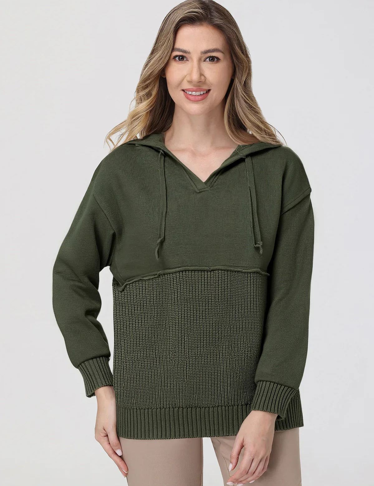 Woman wearing a green hooded sweater with a textured pattern on a white background