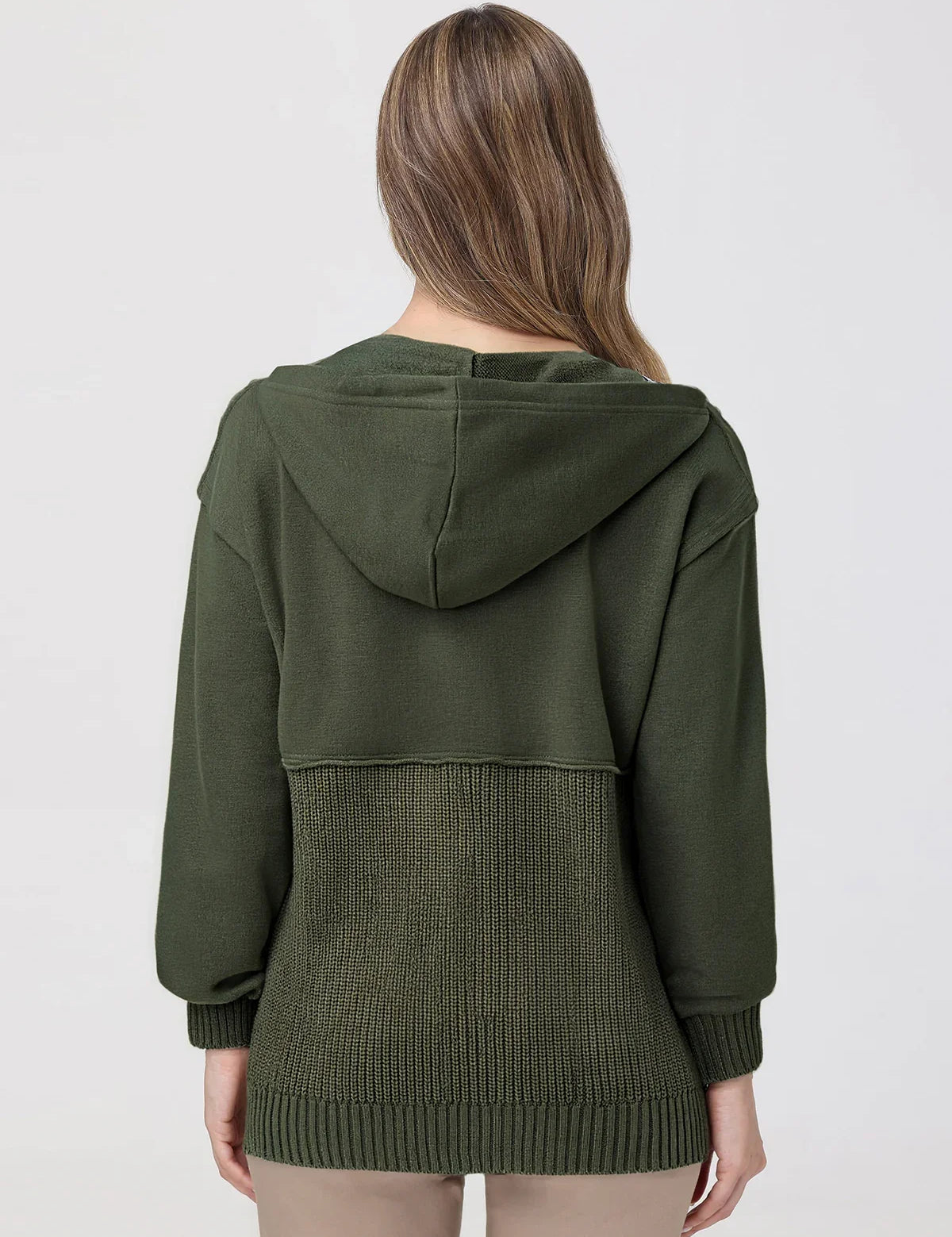 Person wearing a green hoodie with a textured pattern on a plain background