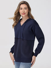 Woman wearing a navy blue hoodie with a white background