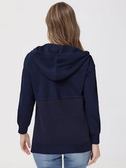 Person wearing a navy blue hoodie on a plain background