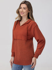 Woman wearing a rust-colored hoodie with a textured pattern on a plain background