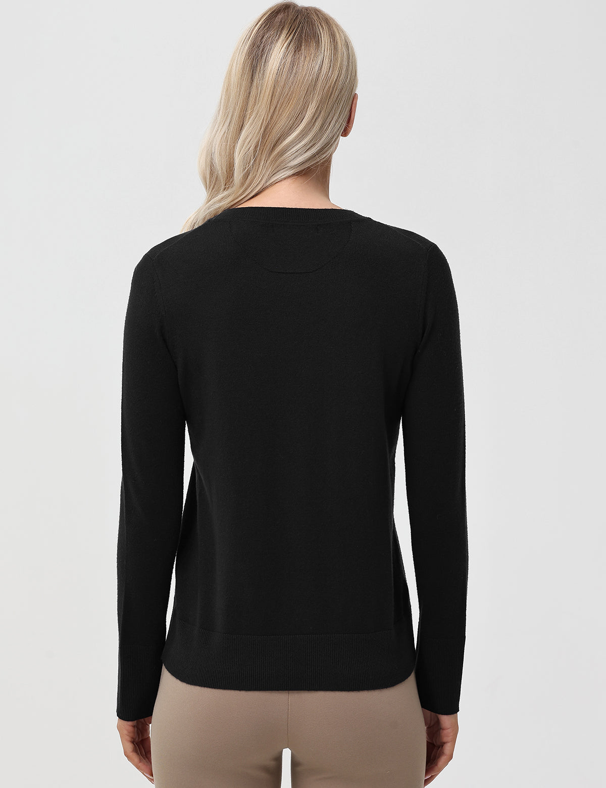 Person wearing a black long-sleeve shirt on a light gray background