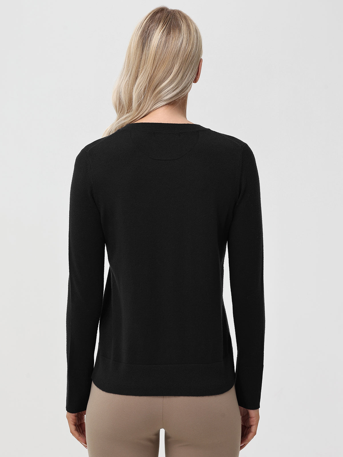 Person wearing a black long-sleeve shirt on a light gray background