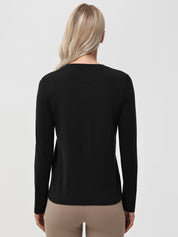 Person wearing a black long-sleeve shirt on a light gray background