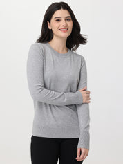 Woman wearing a gray sweater on a white background