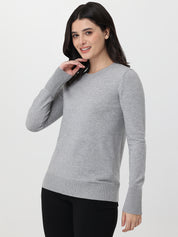 Woman wearing a gray long-sleeve top on a white background