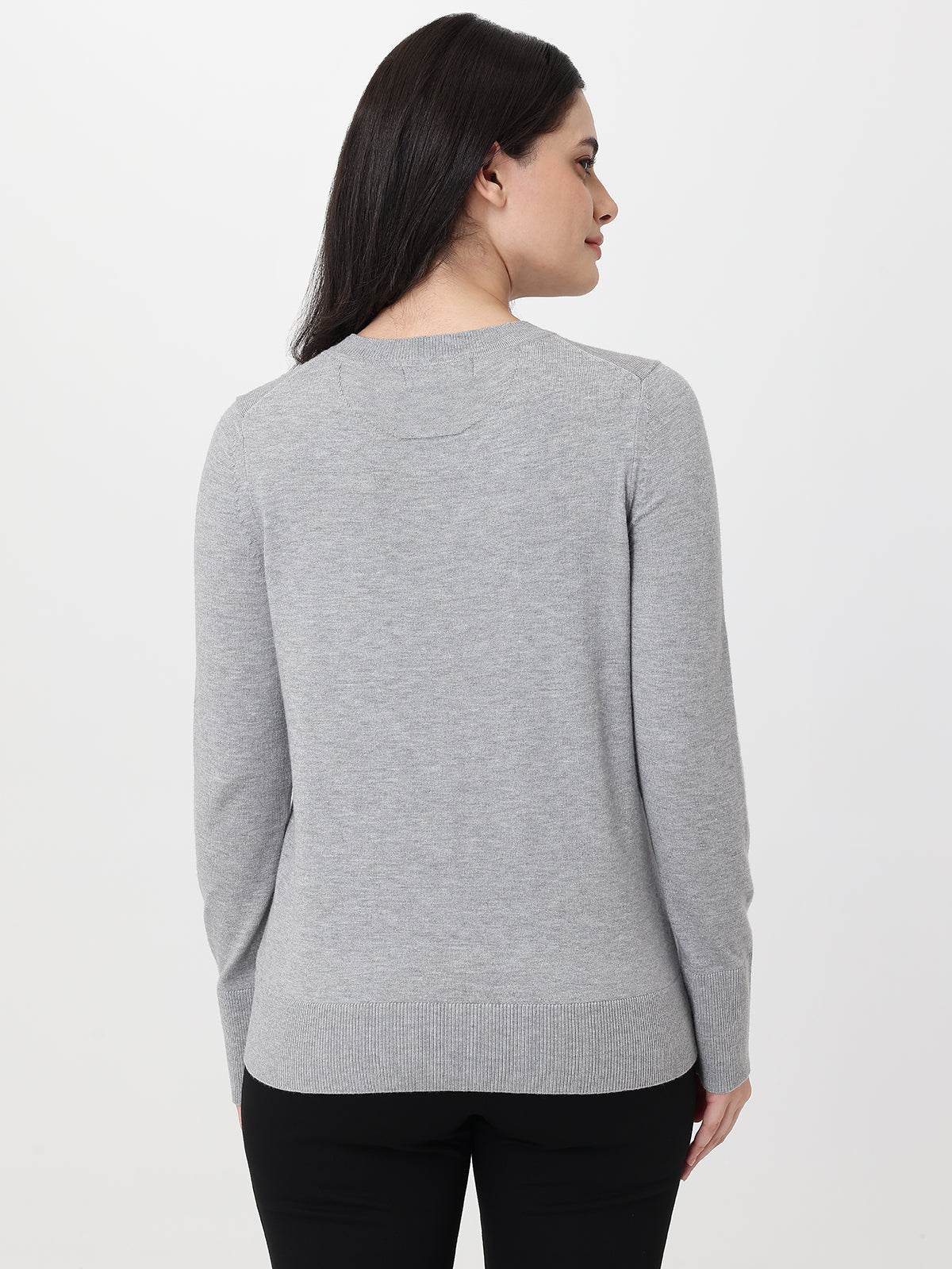 Woman wearing a gray sweater on a white background