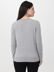 Woman wearing a gray sweater on a white background