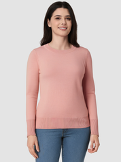 Woman wearing a pink sweater and blue jeans on a white background