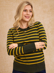 Woman wearing a green and yellow striped sweater against a beige background
