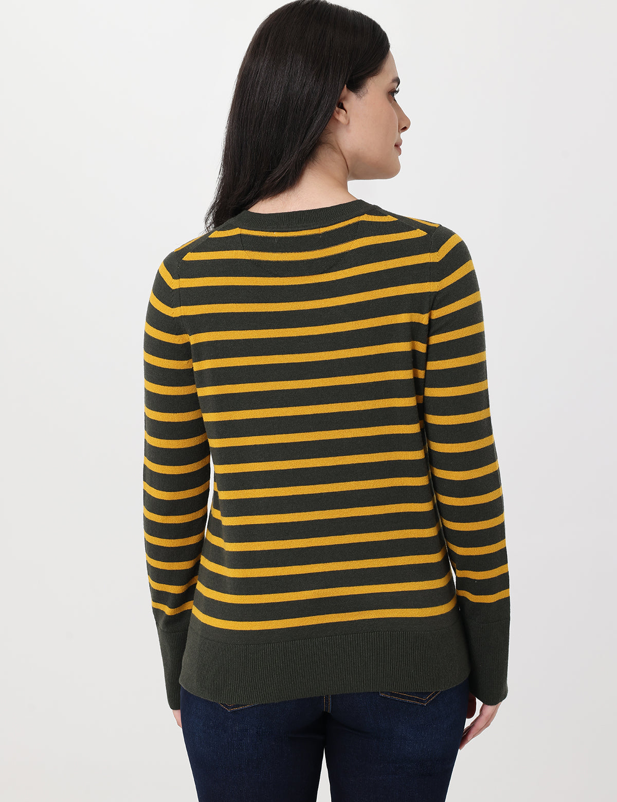 Woman wearing a green and yellow striped sweater on a white background