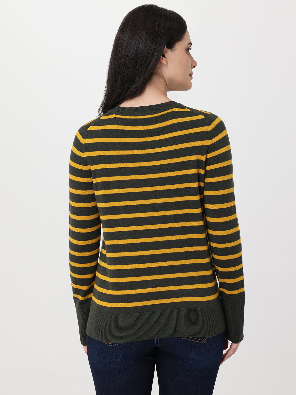 Woman wearing a green and yellow striped sweater on a white background