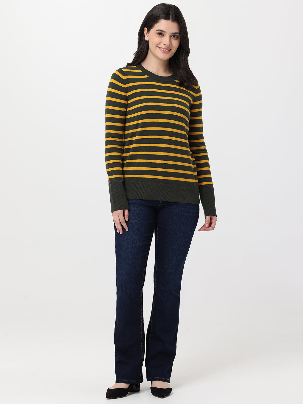 Woman wearing a striped sweater and jeans on a white background