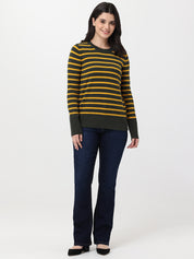 Woman wearing a striped sweater and jeans on a white background