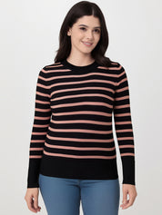 Woman wearing a black and pink striped sweater on a white background