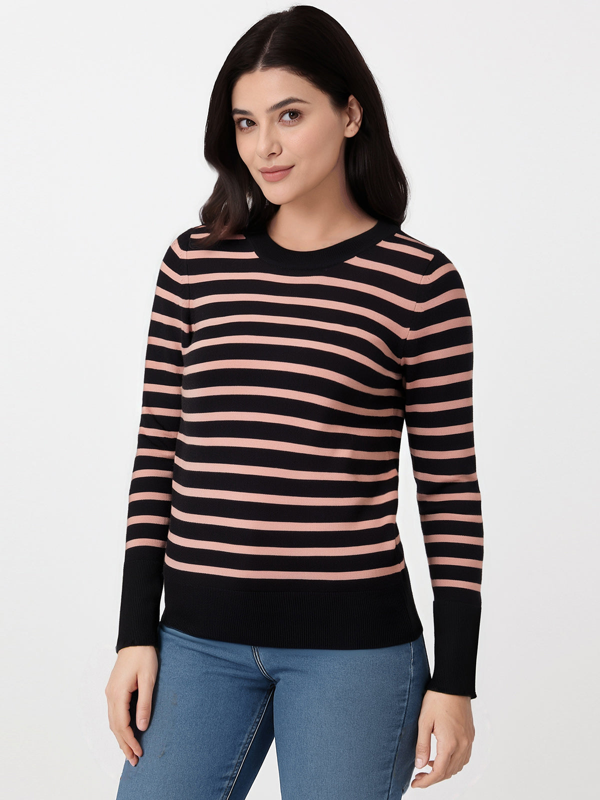 Woman wearing a black and pink striped sweater on a white background
