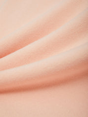 Close-up of pink fabric with subtle texture