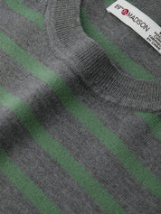 Close-up of a gray and green striped sweater with a brand label.