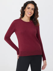 Woman wearing a burgundy sweater on a white background