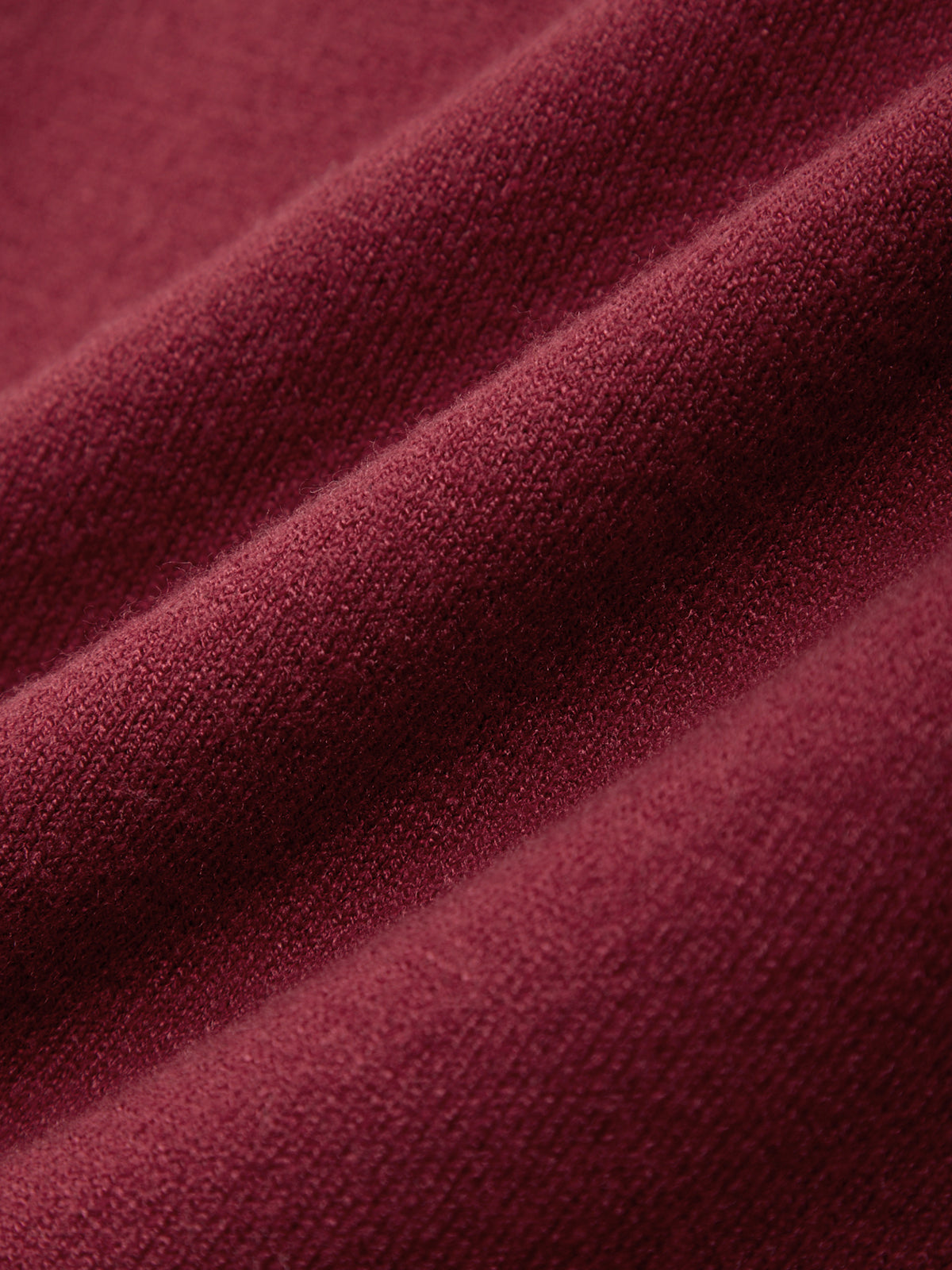 Close-up of a textured burgundy fabric surface