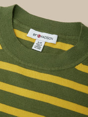 Close-up of a ribbed knit crewneck sweater with horizontal olive green and mustard yellow stripes, showing a white neck label that reads 89th & Madison.
