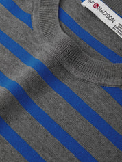 Gray and blue striped sweater with a brand label on a blue background