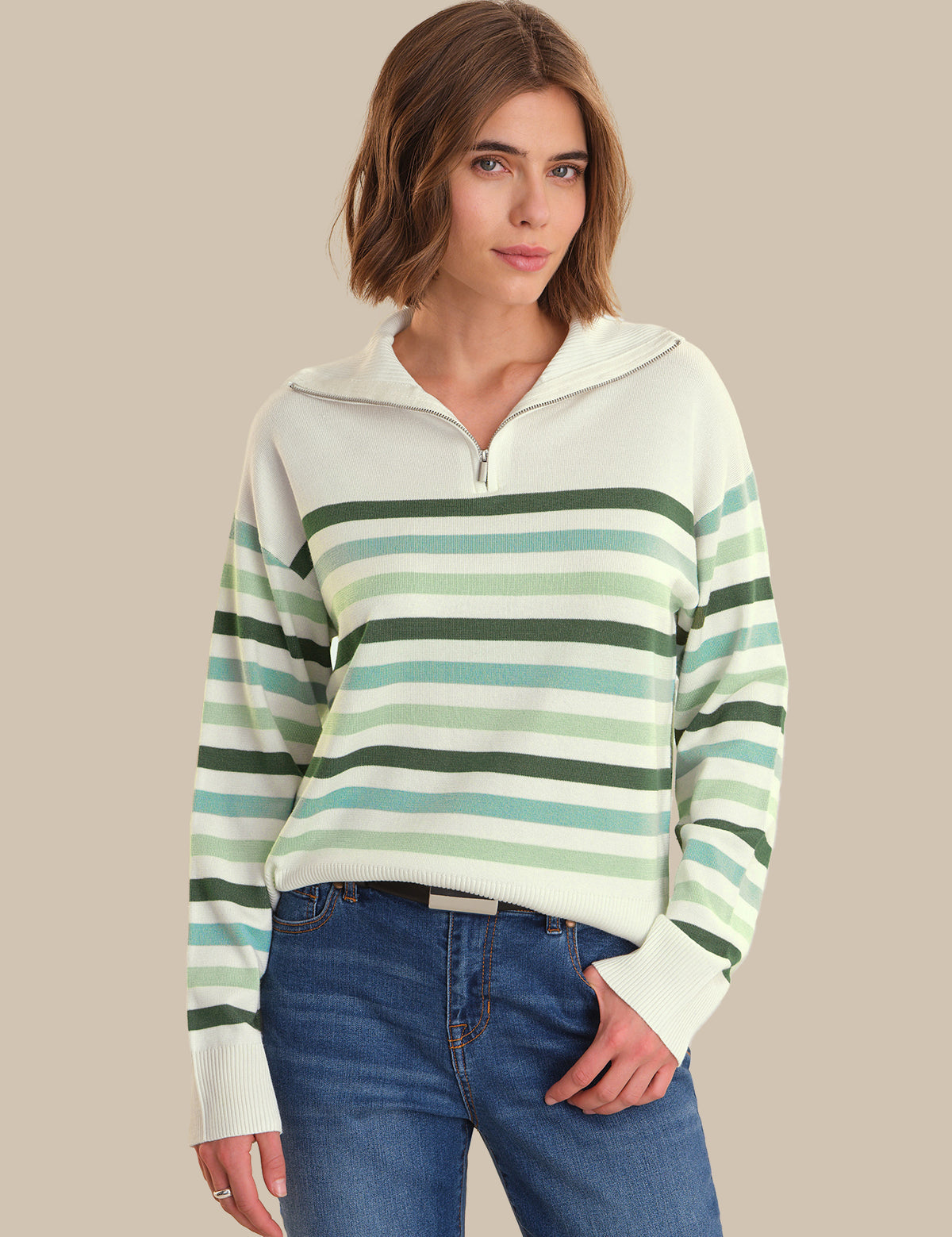 Woman wearing a striped sweater with a neutral background