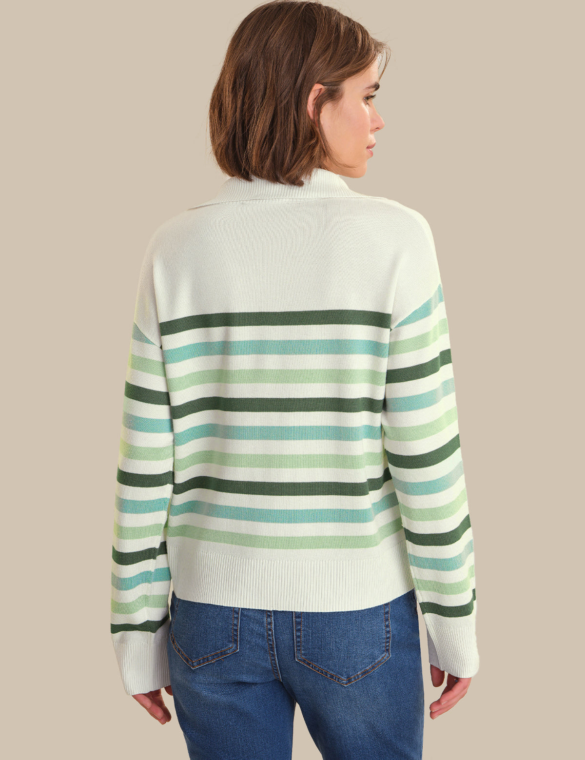 Person wearing a striped sweater with a neutral background