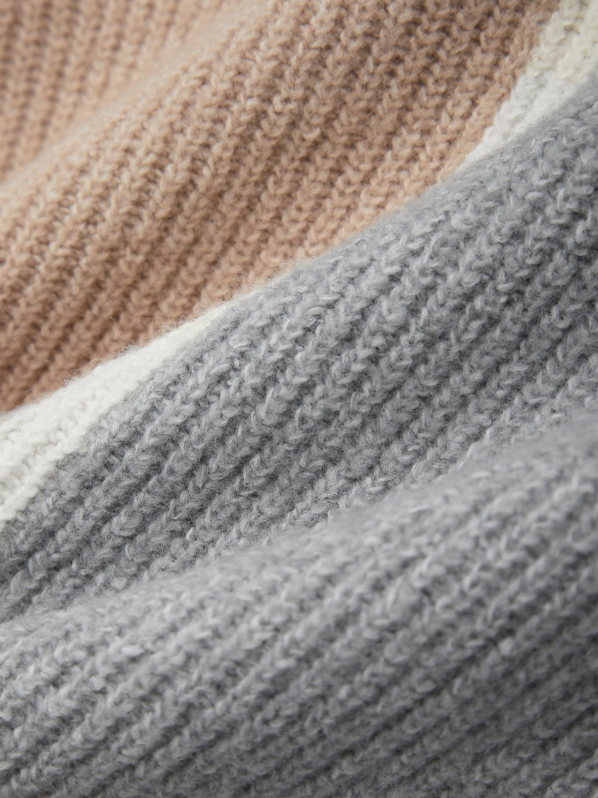 Close-up of textured fabric with a gradient from beige to gray.