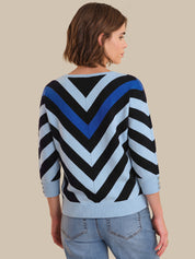 Woman wearing a blue and black striped sweater on a beige background
