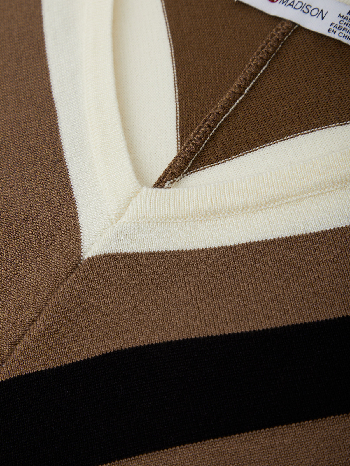 Close-up of a brown and white striped garment with a brand label.