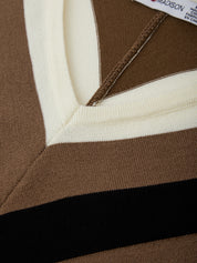 Close-up of a brown and white striped garment with a brand label.