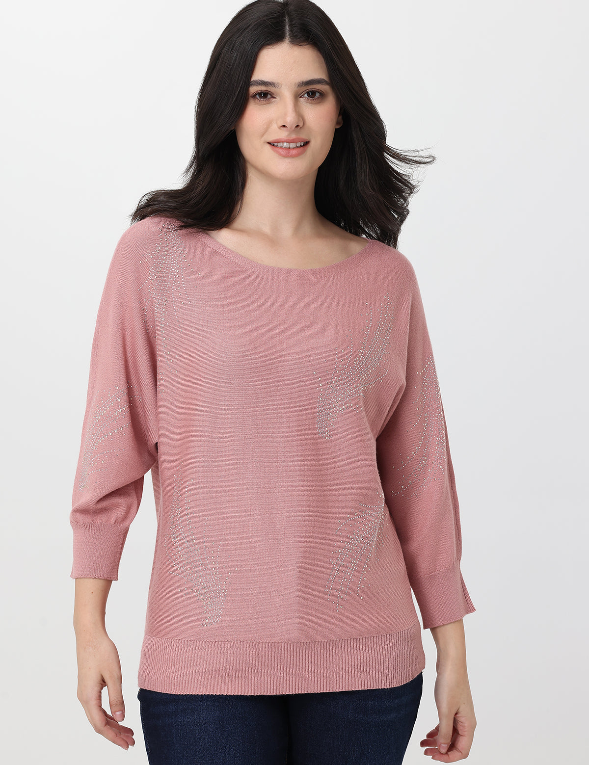 Woman wearing a pink sweater on a white background