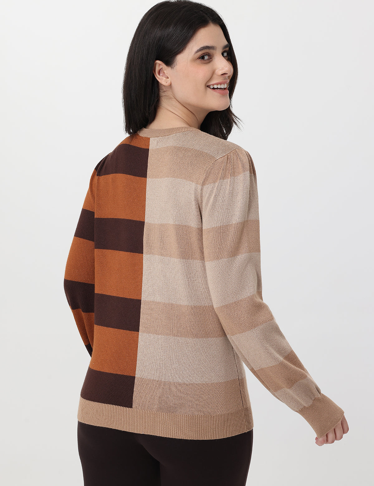 Woman wearing a checkered sweater with brown, beige, and black colors on a white background