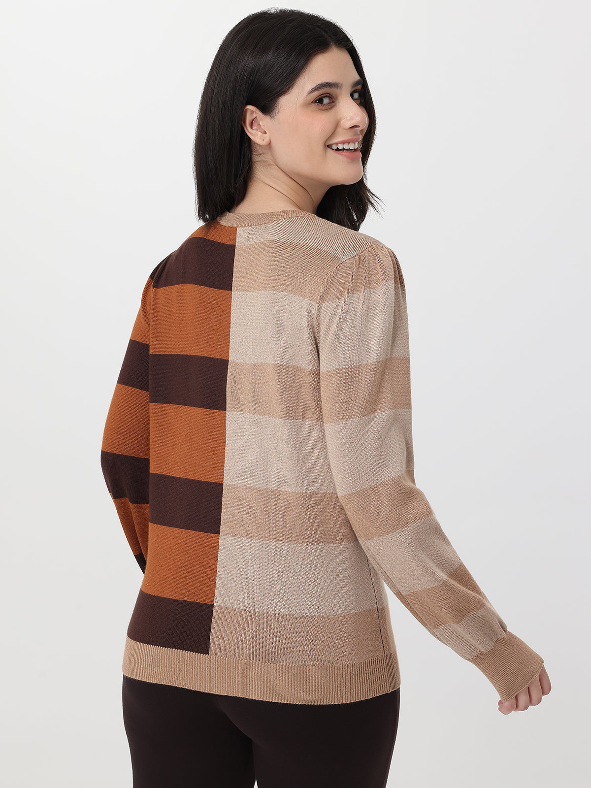 Woman wearing a checkered sweater with brown, beige, and black colors on a white background