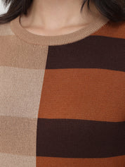 Close-up of a person wearing a sweater with brown and beige color block design.
