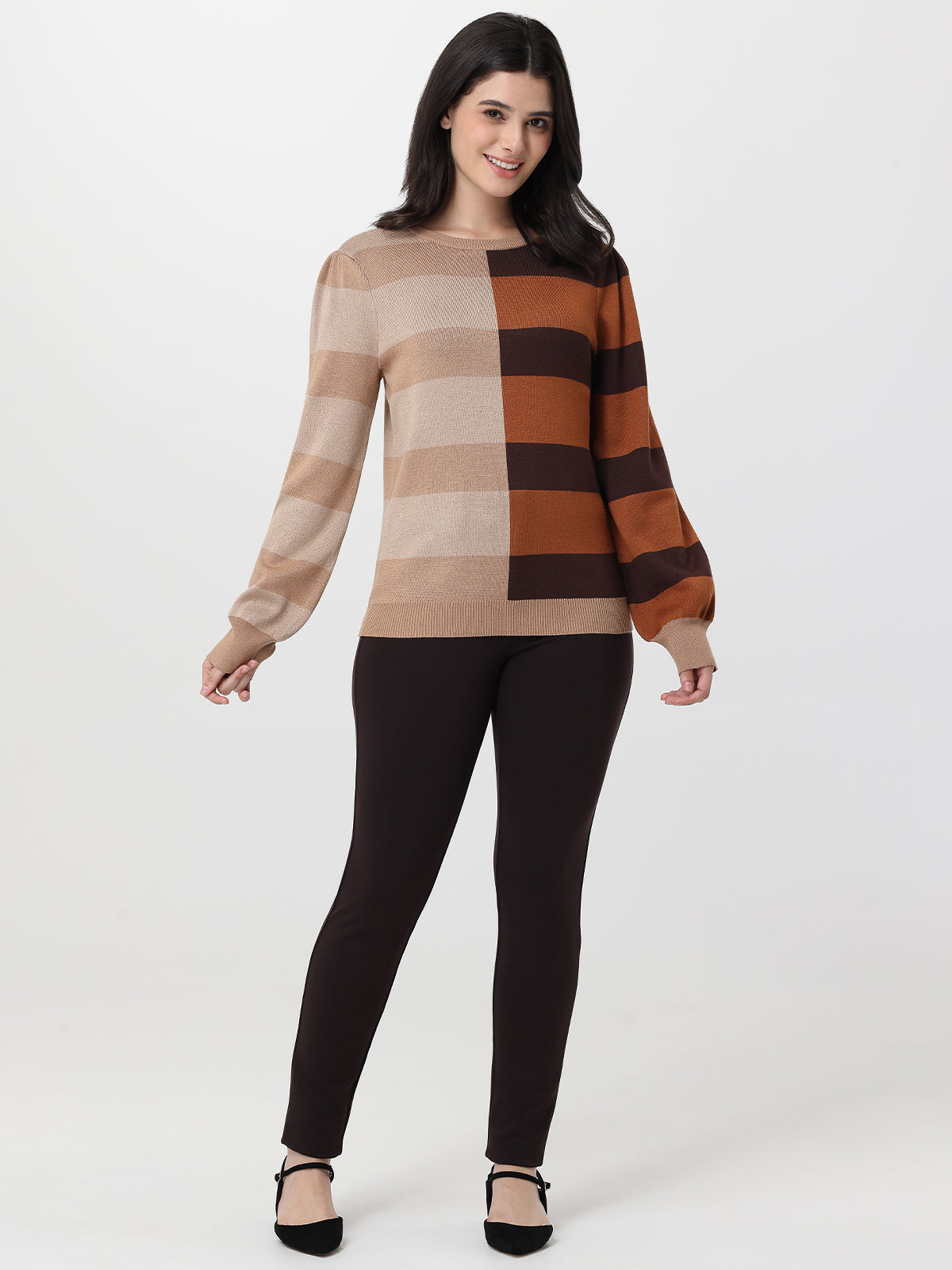 Woman wearing a checkered sweater and black pants on a white background