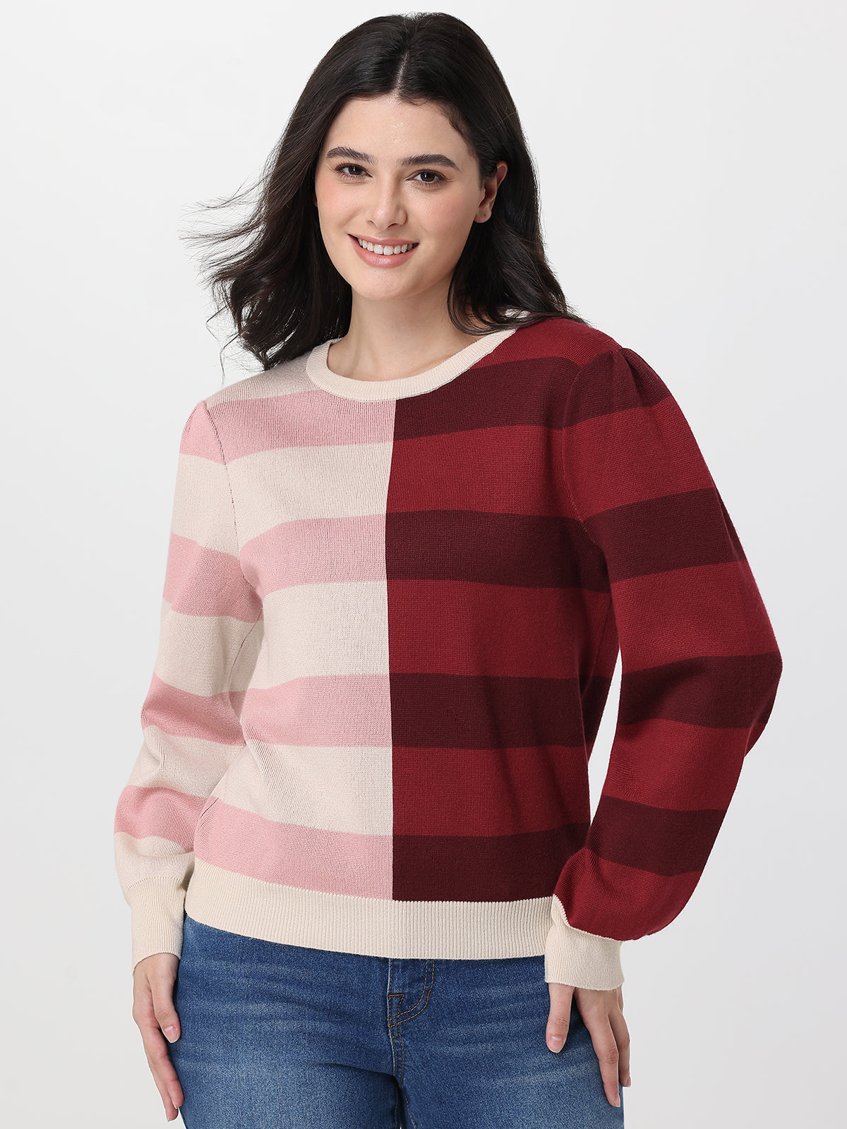 Woman wearing a red and beige striped sweater on a white background