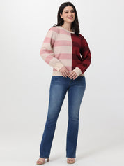 Woman wearing a striped sweater and blue jeans on a white background