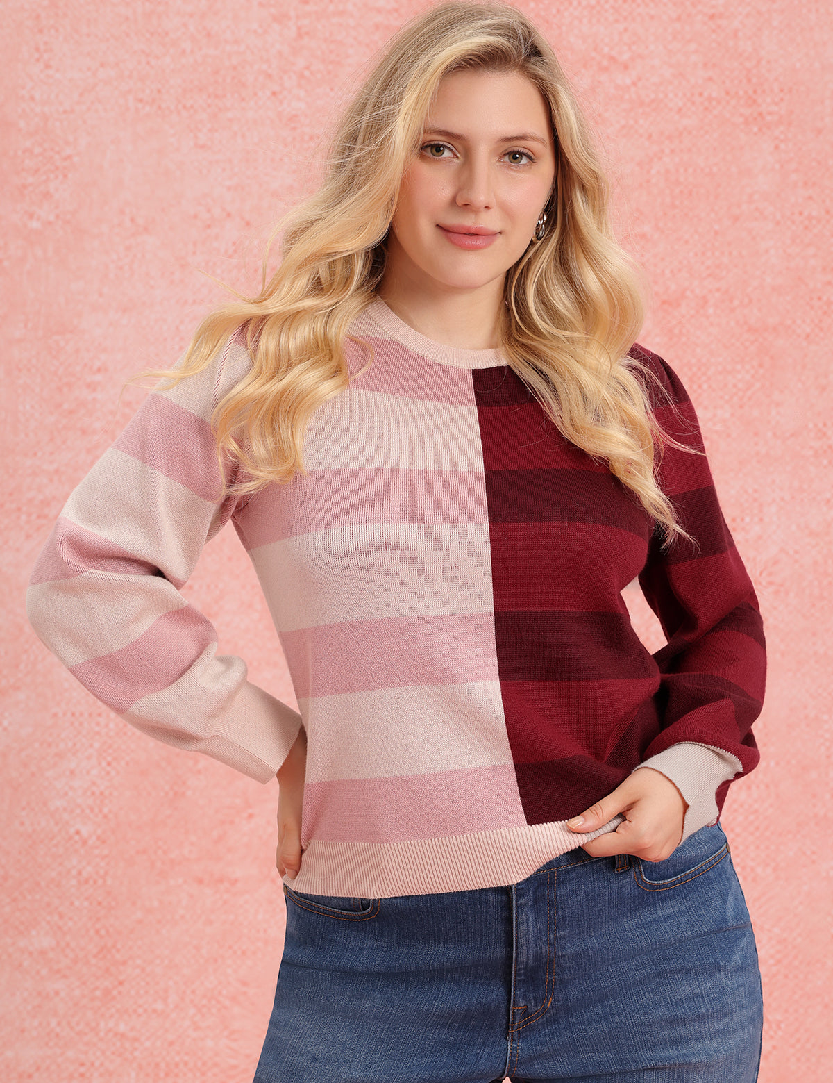 Woman wearing a pink and red striped sweater against a pink background