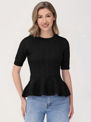 Woman wearing a black peplum top and blue jeans on a white background