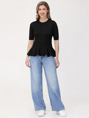 Woman wearing a black peplum top and blue jeans on a white background