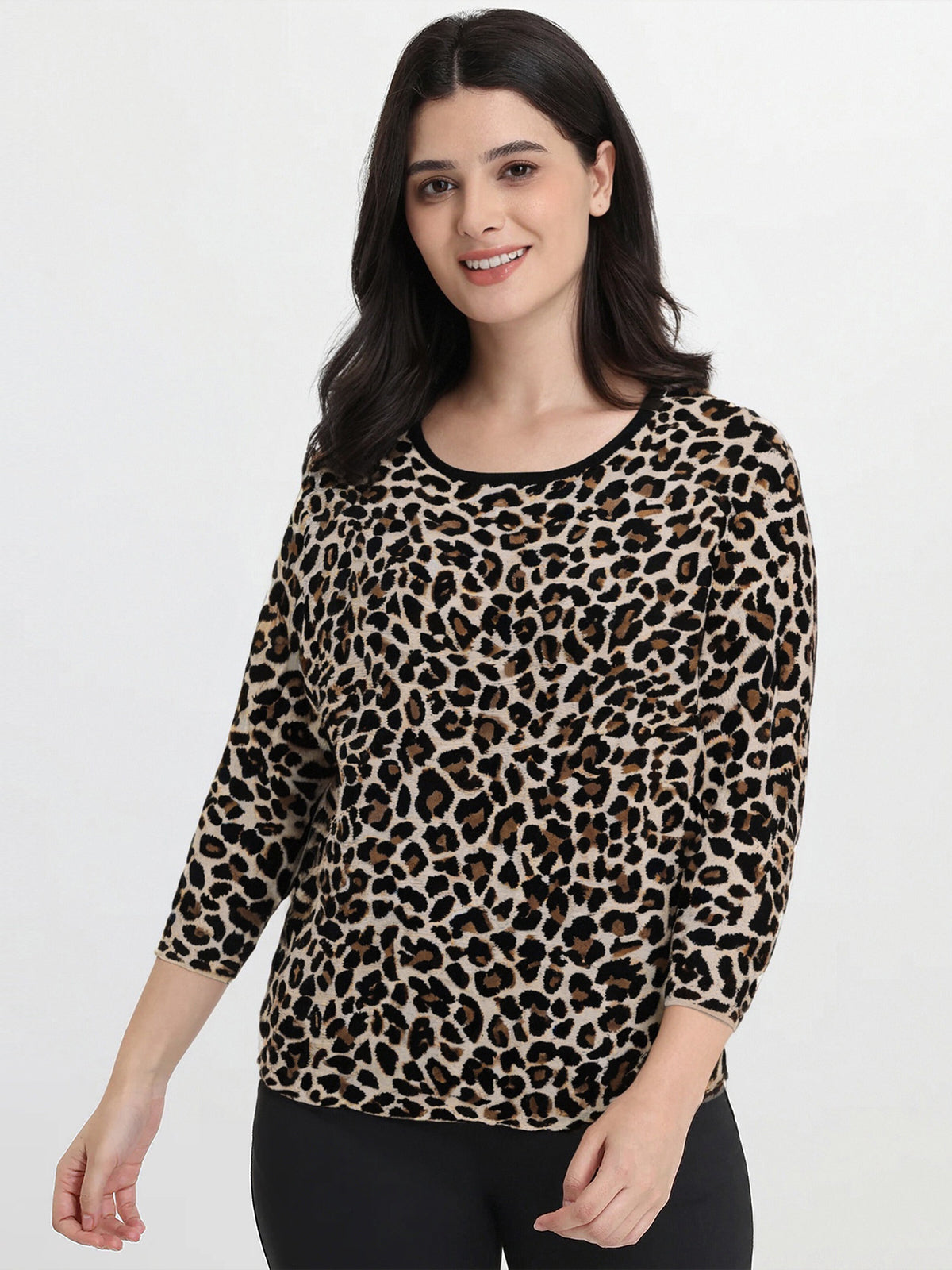 Woman wearing a leopard print top on a white background
