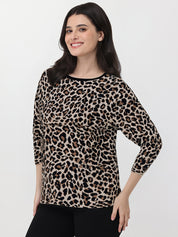 Woman wearing a leopard print top on a white background