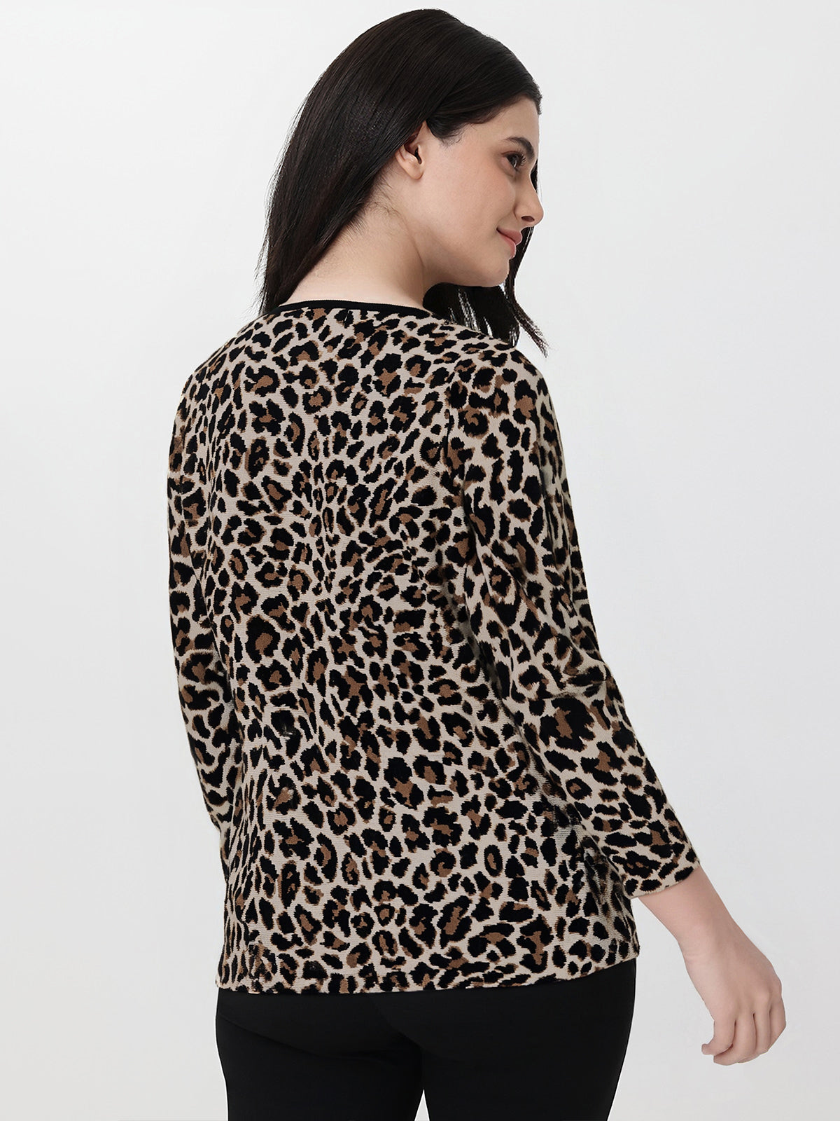 Woman wearing a leopard print top on a white background
