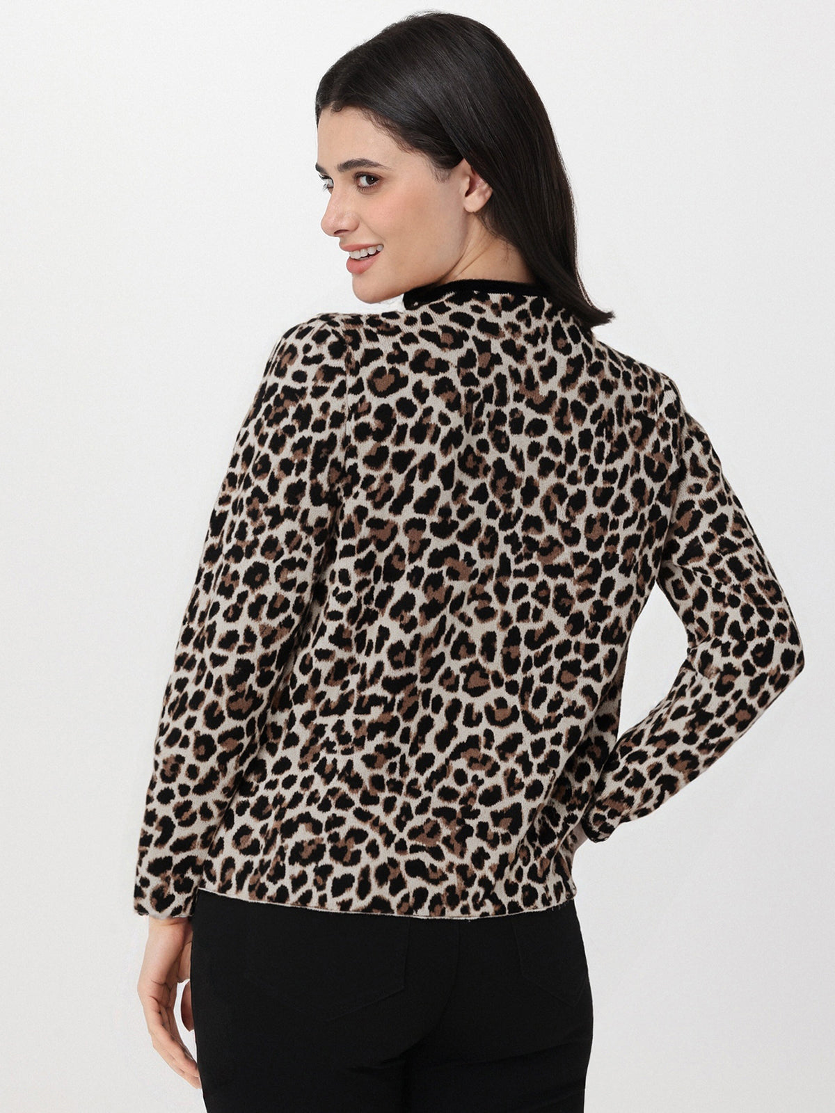 Woman wearing a leopard print blouse against a white background